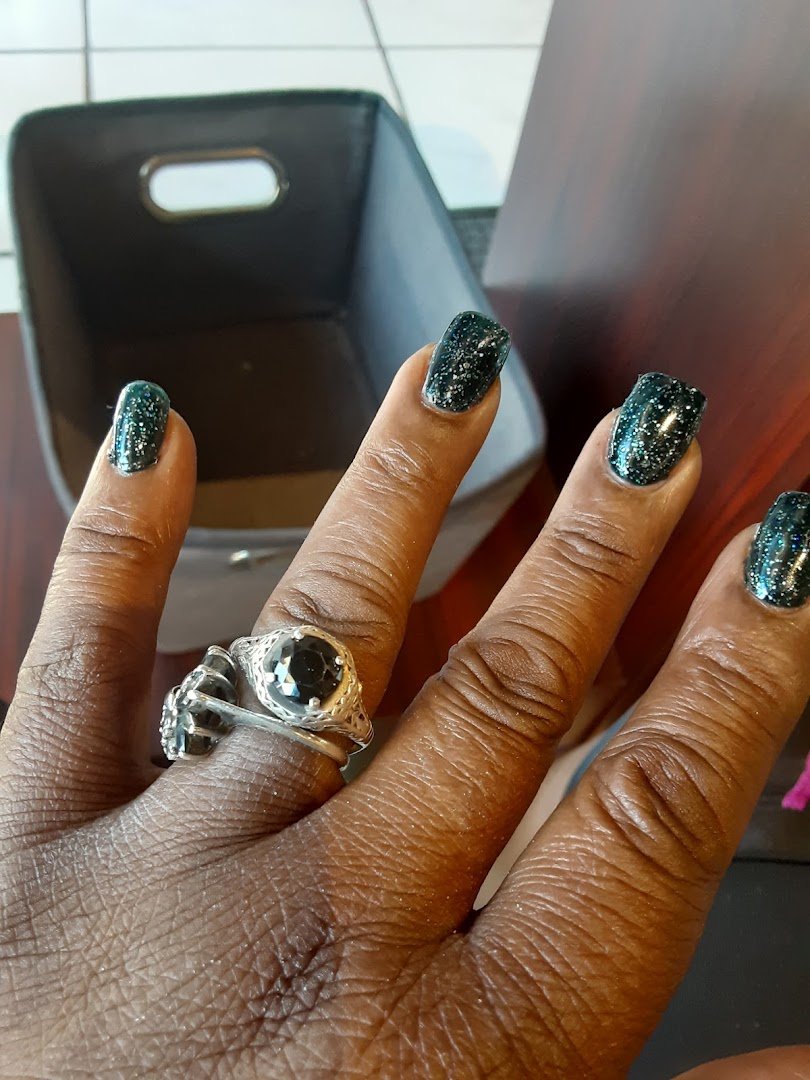 Pedicure chair beside a neat nail salon setup